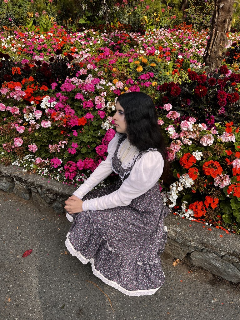 Angie sitting by flowers at Beacon Hill Park