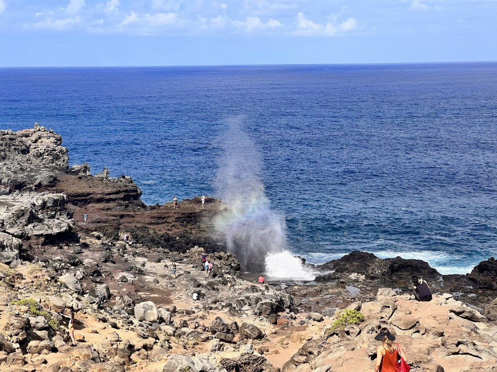 Blowhole with rainbow reflection