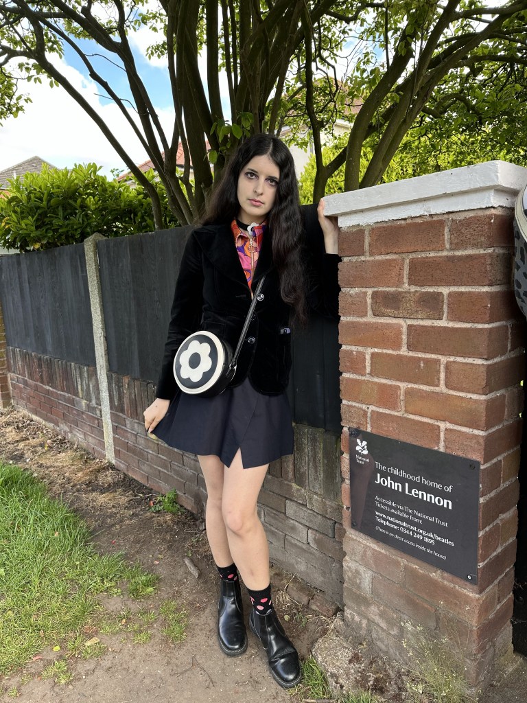 Angie Moon at sign in front of Mendips